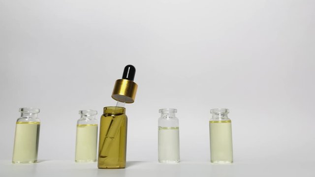 Dolly shot. Three bottles of oil. CBD pipette.  Bottle of Cannabis oil. Oil bottles on white background. Medical cannabis concept. Spruce cbd oil. Oil cbd stock images 