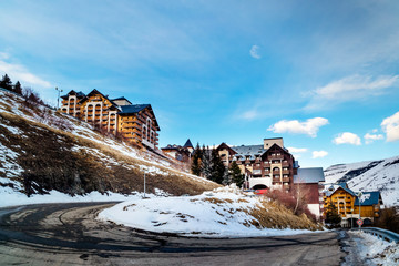 View on alpine village and mountain range with high snowy peaks, Les deux Alpes, French Alps