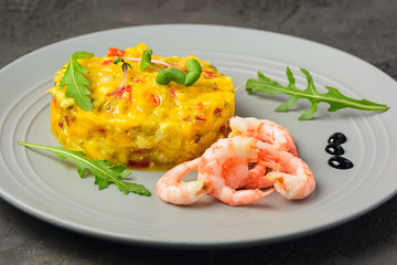On a gray plate are croissants, mango chutney sauce and arugula salad. Close-up photo. National cuisine.