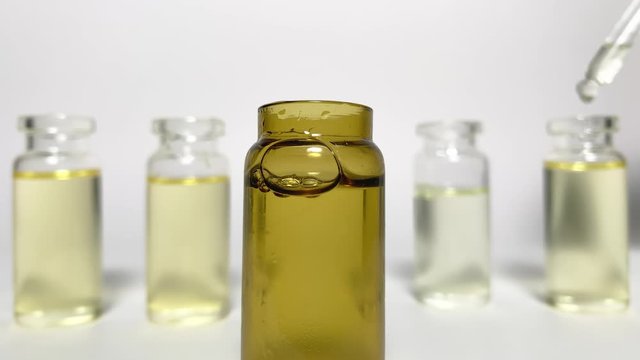 Dripping in a bottle. CBD pipette.  Bottle of Cannabis oil. Oil bottles on white background. Medical cannabis concept. Spruce cbd oil. Oil cbd stock images 