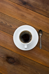 Coffee cup isolated on wooden table. Top view, flat lay coffee drink with copy space. Vertical image.