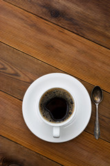 Coffee cup isolated on wooden table. Top view, flat lay coffee drink with copy space. Vertical image.