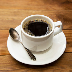 Coffee cup isolated on wooden table. Top view, flat lay coffee drink with copy space.