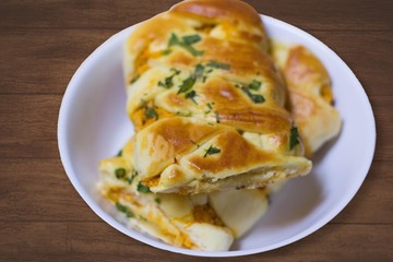 Braided stuffed bread with chicken and catupiry and cilantro on top. known in Brazil as 