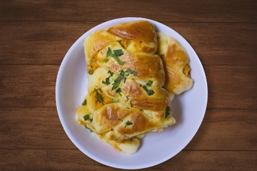 Braided stuffed bread with chicken and catupiry and cilantro on top. known in Brazil as 