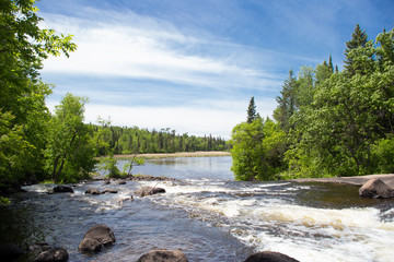 Rapids on river to lake in forest