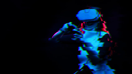 Naklejka premium Woman with virtual reality headset is playing game. Image with glitch effect.