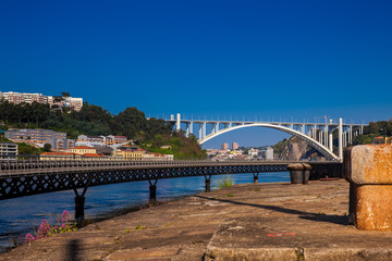 View of the Duoro River and the Cais das Pedras Viaduct in a beautiful early spring day at Porto City in Portugal
