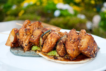 Chicken skewers fried in sesame oil, cuisine with oriental flavor in Guatemala, Central America.