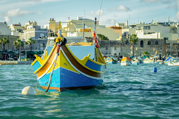Fototapeta na wymiar A luzzu is a traditional fishing boat from the Maltese islands. Painted in bright colours, luzzus have existed sin