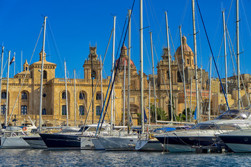 Sailboats sitting in the port in front of old city