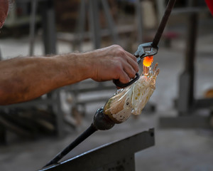 The glassblowers also use their hands and basic tools to shape the molten glass in traditional way