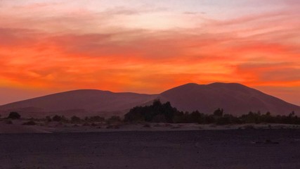 Red sky after sunset at camp in Sahara Desert in Morocco