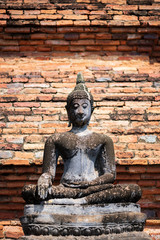 Fototapeta premium Buddha image at Wat Mahathat in Sukhothai Historical Park, Thailand. Buddha statue used as amulets of Buddhism religion. Sukhothai Historic Park.