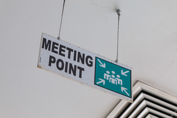 Acrylic Meeting point sign attached on ceiling. View from below