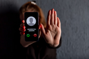 Phone call from unknown number. Scam, fraud or phishing with smartphone concept. Prank caller, scammer or stranger. Woman answering to incoming call. Hoax person with fake identity