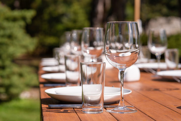 Served wooden table without a tablecloth. Cafe in the open air park