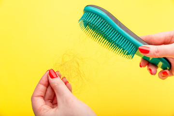 young woman worried about hair loss on a white background