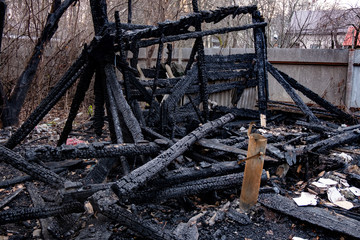 Consequences of fire. Completely burnt wooden house