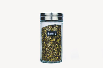 SPICE BASIL IN GLASS BOTTLE ON WHITE BACKGROUND