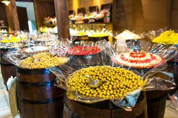 Confectionery shop in retro style. Colorful candies and sweets in wooden barrels.