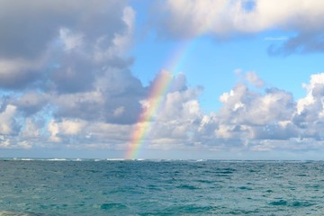 Rainbow over water in summertime