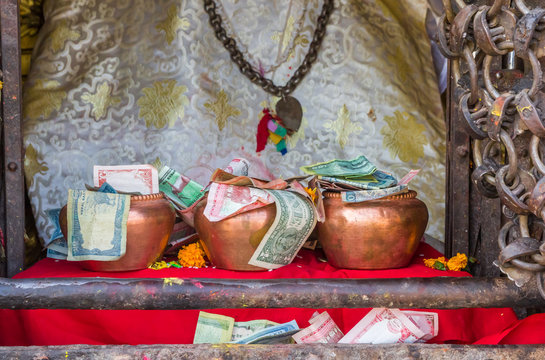 Bowls with donated money at the Swayambhunath temple in Kathmandu