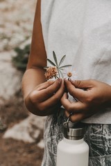 hands of woman girl flowers