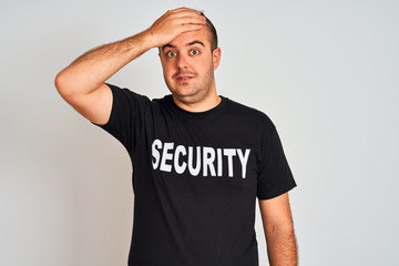 Young safeguard man wearing security uniform standing over isolated white background stressed with...