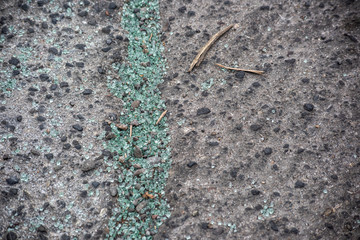 Pieces of broken glass on the asphalt