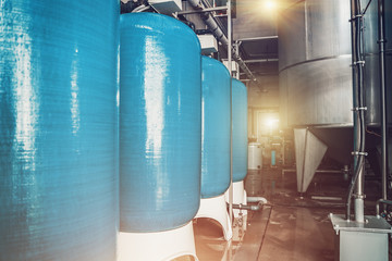 Drinking water factory or plant production, industrial interior. Metal tanks for filtering water, toned