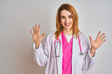 Redhead caucasian doctor woman wearing pink stethoscope over isolated background showing and pointing up with fingers number ten while smiling confident and happy.