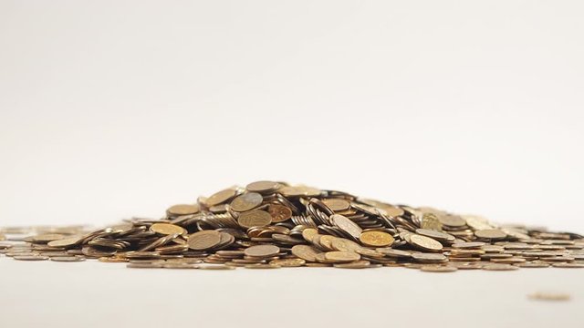 White-gloved hands scooping up a pile of gold coins. They sort out and scatter money.On white background. Garland. Money glitters.