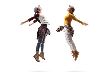 Young women performing a dance jump