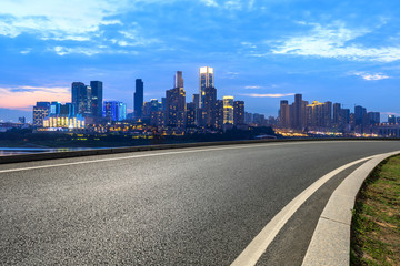 Fototapeta na wymiar Empty asphalt road and city skyline with buildings in Chongqing at sunset,China.