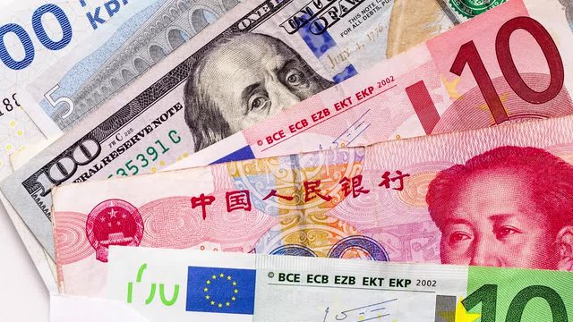Different currency banknotes, including euros, Chinese yuan and one hundred US dollars, close up shot, top view panning. background concept of wealth and global travel 
