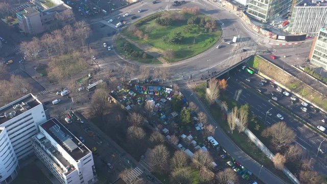 Immigrants living next to a roundabout Paris homeless dramatic social aerial shot 