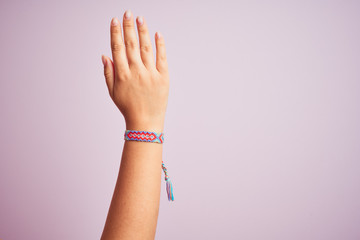 Model arm with beautiful handmade colorful bracelet on wrist