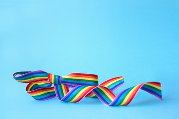 LGBT concept. Bow from a rainbow ribbon on a blue background