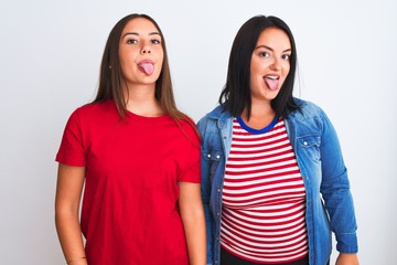 Young beautiful women wearing casual clothes standing over isolated white background sticking tongue out happy with funny expression. Emotion concept.