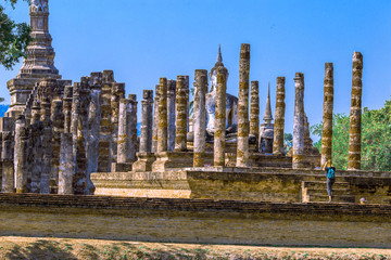 Background, the landmark of the Buddhist tourist attraction in Sukhothai Historical Park, tourists...