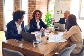 Group of business workers smiling happy and confident. Speaking with smile on face working together at the office.
