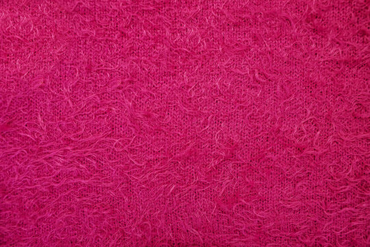 Texture of pink woolen fabric. It can be used as a background, the pile looks original with text