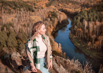 Naklejka premium Young Blonde Walking On top of a mountain in autumn