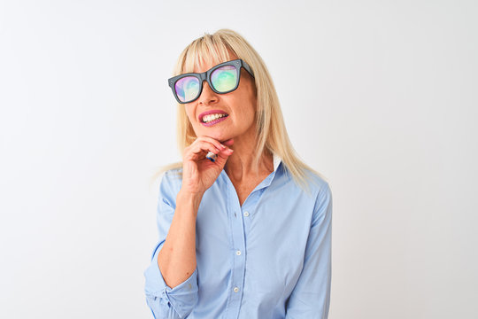Middle age businesswoman wearing glasses and shirt standing over isolated white background serious face thinking about question, very confused idea