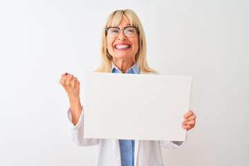 Middle age scientist woman wearing glasses holding banner over isolated white background screaming proud and celebrating victory and success very excited, cheering emotion