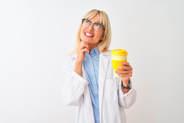 Middle age scientist woman wearing glasses drinking coffee over isolated white background serious face thinking about question, very confused idea