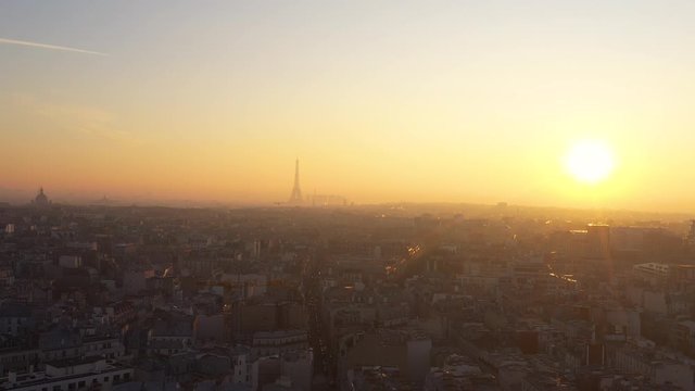 Sun setting over Paris Skyline Eiffel Tower rooftops France capital 