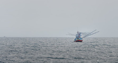 Thai fishing boat use boom and net to catch Schooling  fish in the sea