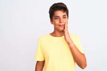 Handsome teenager boy standing over white isolated background touching mouth with hand with painful expression because of toothache or dental illness on teeth. Dentist concept.